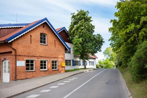 an empty road next to a brick building at Nidos Banga in Nida