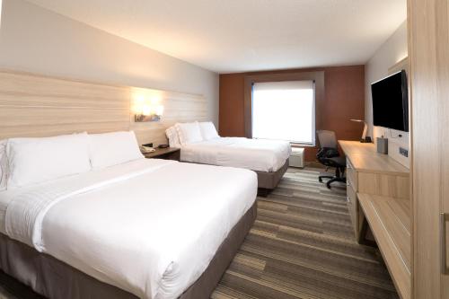 a hotel room with two beds and a television at Holiday Inn Express & Suites - Gaylord by IHG in Gaylord