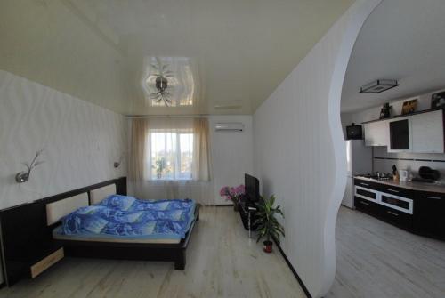 a bedroom with a bed and a staircase in a room at Квартира в центре Черемушек in Odesa