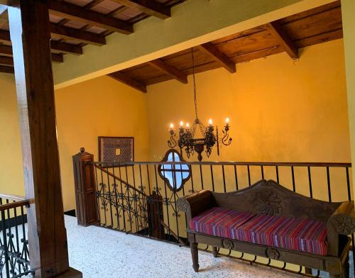 a living room with a couch and a chandelier at Hotel Posada San Miguel in Antigua Guatemala