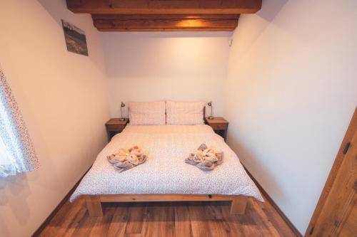 a bedroom with a bed with teddy bears on it at Penzion Horský statek in Šumavské Hoštice