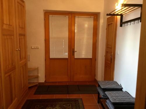 a hallway with a door and a bench in front of it at Apartment Mařenka Frymburk in Frymburk