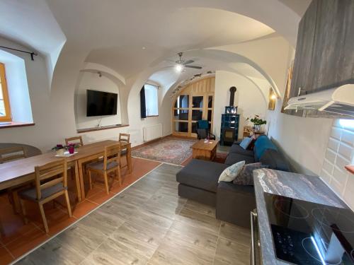 a living room with a couch and a table at Apartment Mařenka Frymburk in Frymburk