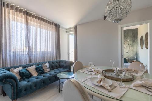 a living room with a blue couch and a table at Boutique Style – 2 Bedroom Apartment- Ta’Xbiex, Sliema area in Taʼ Xbiex