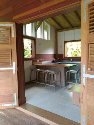 a kitchen with a large island in a house at Un cosy sous le vent in Gourbeyre