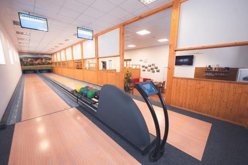 a bowling alley with a person laying on the lanes at Penzion Horský statek in Šumavské Hoštice