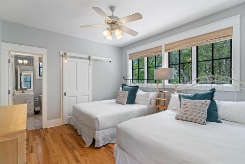 a bedroom with two beds and a ceiling fan at 13 Lake District Lane in Santa Rosa Beach