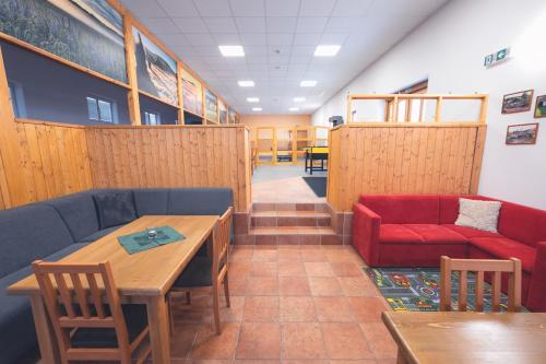 a waiting room with a couch and a table at Penzion Horský statek in Šumavské Hoštice