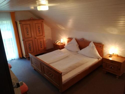 a bedroom with a large bed with two night stands at Hotel Waldhaus in Bodenmais