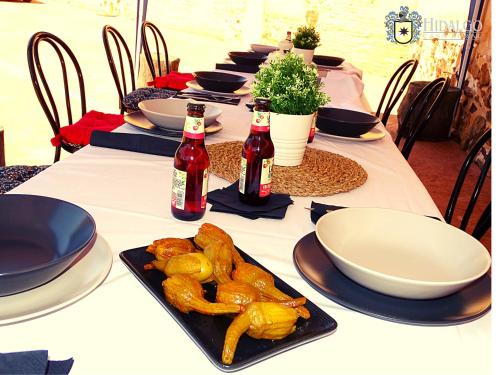 a long table with plates of food on it at Casa Rural Hidalgo in Ciudad Real