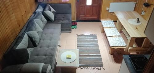 a living room with a couch and a table at Vikendica Pavle in Vrhpolje