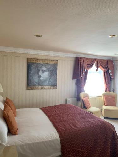 a bedroom with a large bed and a window at The Old Coach House in Blackpool