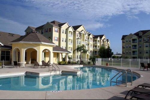 a swimming pool in front of a apartment complex at LUXURY and VINTAGE space to enjoy your vacation!! in Kissimmee