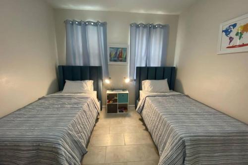 two beds sitting next to each other in a room at LUXURY and VINTAGE space to enjoy your vacation!! in Kissimmee