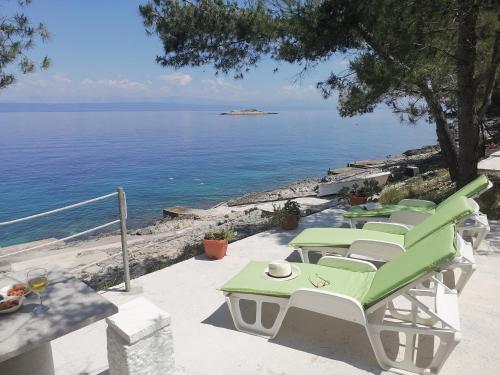 a patio with a table and chairs and the ocean at Apartment D&D in Prigradica