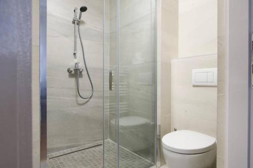 uma casa de banho com uma cabina de duche em vidro e um WC. em Premium Apartment by Hi5-Vaci str. 3 bedroom (219) em Budapeste