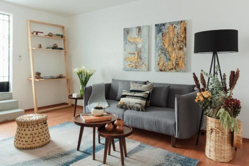 a living room with a couch and a table at Jardín Roma By The Local Way in Mexico City
