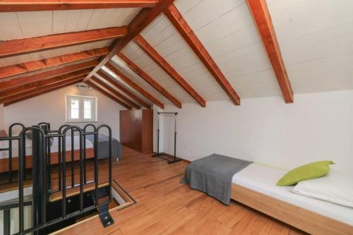 a room with two beds in a attic at Kuća za odmor Mihaela in Sutivan