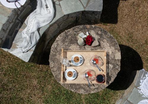 a table with a plate of food on top of a table at Villa Tsitreli in Sikia
