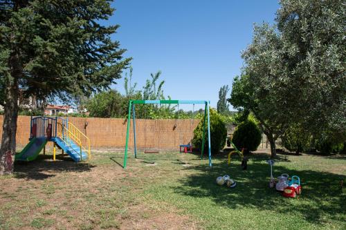 a park with a playground with a swing at Villa Tsitreli in Sikia