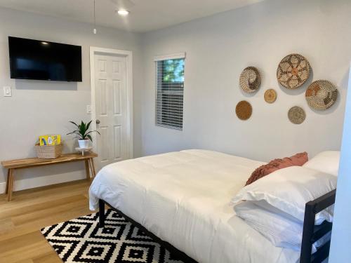 a bedroom with a bed and a flat screen tv at Steps To The Beach, Pacific City and Main Street - Studio in Huntington Beach