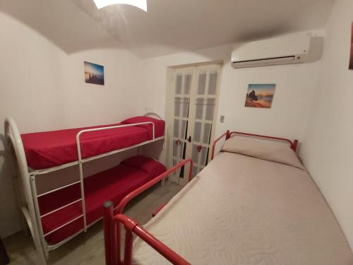 a small room with two bunk beds in it at Villa l'Amante in Fondi