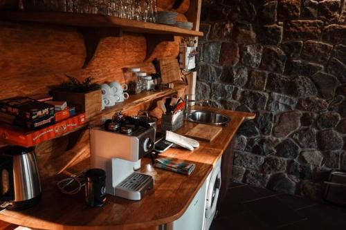 a kitchen with a counter with a coffee maker on it at Piparmētras in Mērsrags