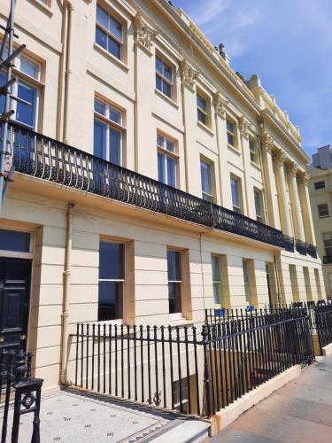 a building with a fence in front of it at 99 Steps to the Sea in Brighton & Hove