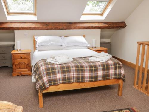 ein Schlafzimmer mit einem Bett mit zwei Handtüchern darauf in der Unterkunft Bay Horse Cottage in Skipton