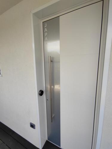 a sliding glass door in a bathroom with a refrigerator at B&B Le Nazioni in Lido delle Nazioni