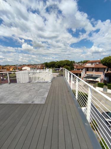 a wooden deck with a white railing on a roof at B&B Le Nazioni in Lido delle Nazioni