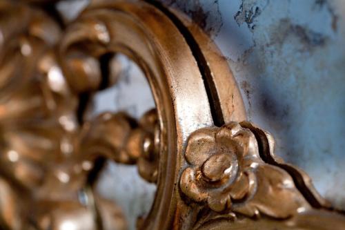 a close up of a mirror with a gold frame at Ermitage - Mont-Saint-Michel in Beauvoir