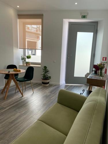 a living room with a couch and a table at ValentinaPlace in Alcácer do Sal