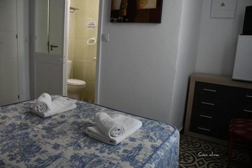 pokój hotelowy z dwoma ręcznikami na łóżku w obiekcie Hostal Costa de la Luz w mieście Chipiona