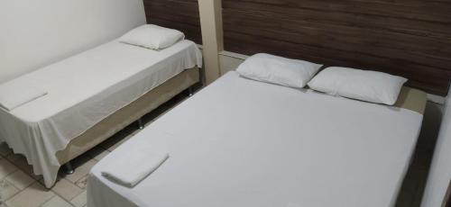 Una cama o camas en una habitación de Pousada Barrancas