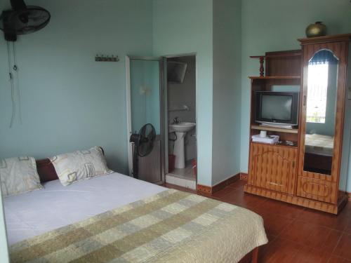 a bedroom with a bed and a tv in it at Phuong Mai Family Hotel in Cat Ba