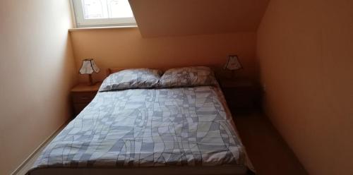- une petite chambre avec un lit et une fenêtre dans l'établissement SZÓSTKA, à Rewal