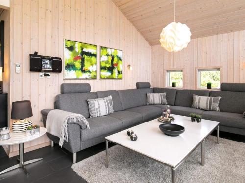 a living room with a couch and a table at 8 person holiday home in Bl vand in Blåvand