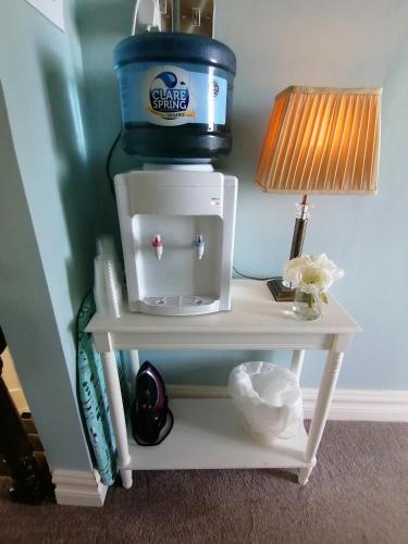 a table with a coffee maker on top of it at Wild Atlantic Lodge Bed & Breakfast in Lahinch