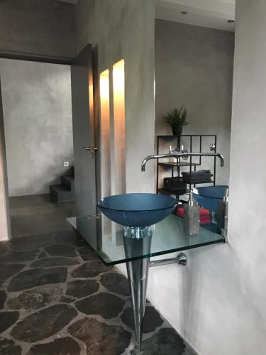 a bathroom with a blue sink and a mirror at Tórhús in Miðvágur