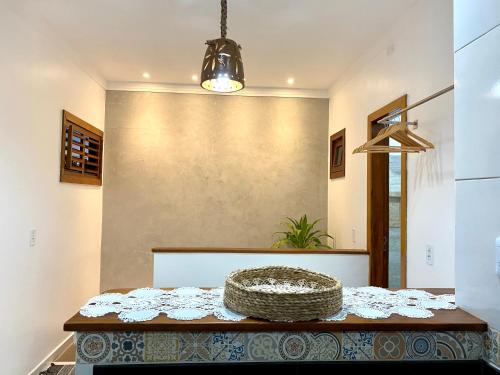 a dining room table with a basket on top of it at Acoara PRAIA in Jericoacoara