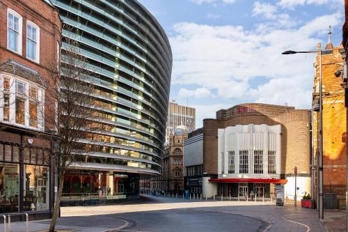 a city street with a tall glass building at The Acacia, Luxury with Private Balcony + Parking in Leicester