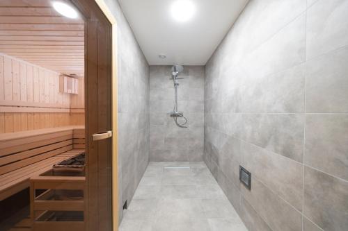a bathroom with a shower and a walk in shower at Apartamenty BALTIVIA Olimpijska 2 in Mielno