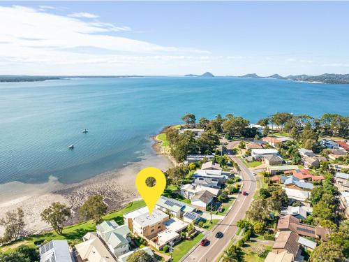 an aerial view of a beach with a yellow marker at Pelican Sands 2 fantastic waterfront unit with pool and air conditioning in Soldiers Point