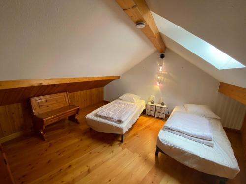a attic room with two beds and a piano at Appartement Montgenèvre, 2 pièces, 6 personnes - FR-1-445-164 in Montgenèvre