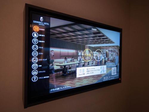 a television screen with a picture of a restaurant at Granbell hotel Tanuki, Sapporo in Sapporo