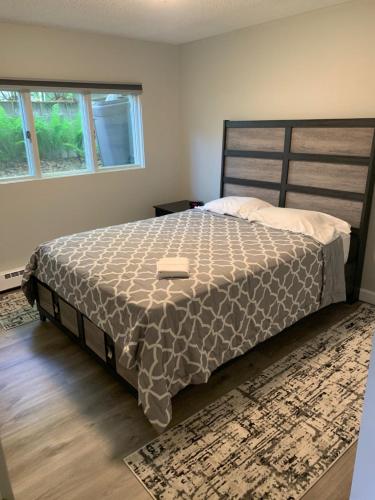 a bedroom with a large bed with a brown comforter at The Chugach at 1400K in Anchorage
