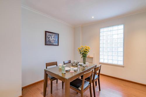 a dining room with a table and chairs and a window at WECOZY HANOI - Railway Side, The Old Quarter in Hanoi