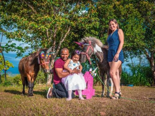 a man and a woman and a child and a horse at Linda casa de verano con amplias zonas verdes in San Isidro