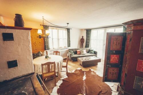 a living room with a table and a couch at Stodingerhütte in Winkl